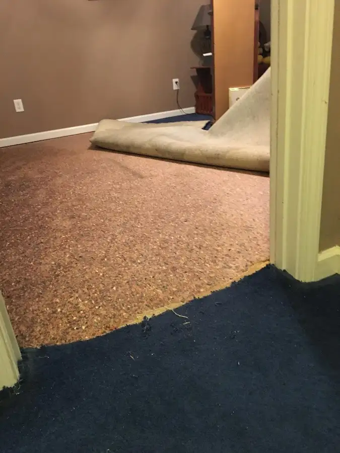 Carpet pad removal revealing water damage during Drying & Dehumidification in Austin
